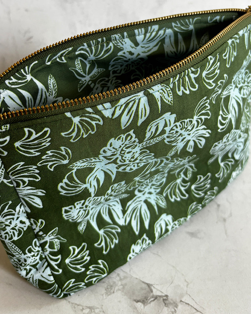 Green pouch with blue floral pattern on a marble surface