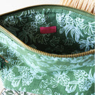 Green floral-patterned pouch with a pink label on a white background