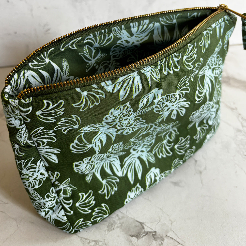Green pouch with blue floral pattern on a marble surface